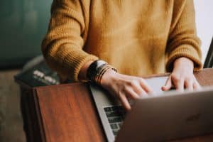 a woman typing on laptop