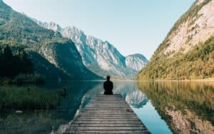 a person sitting beside a lake