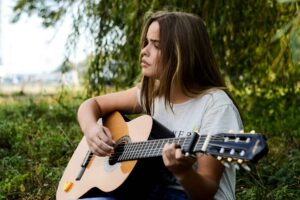 a woman playing a guitar