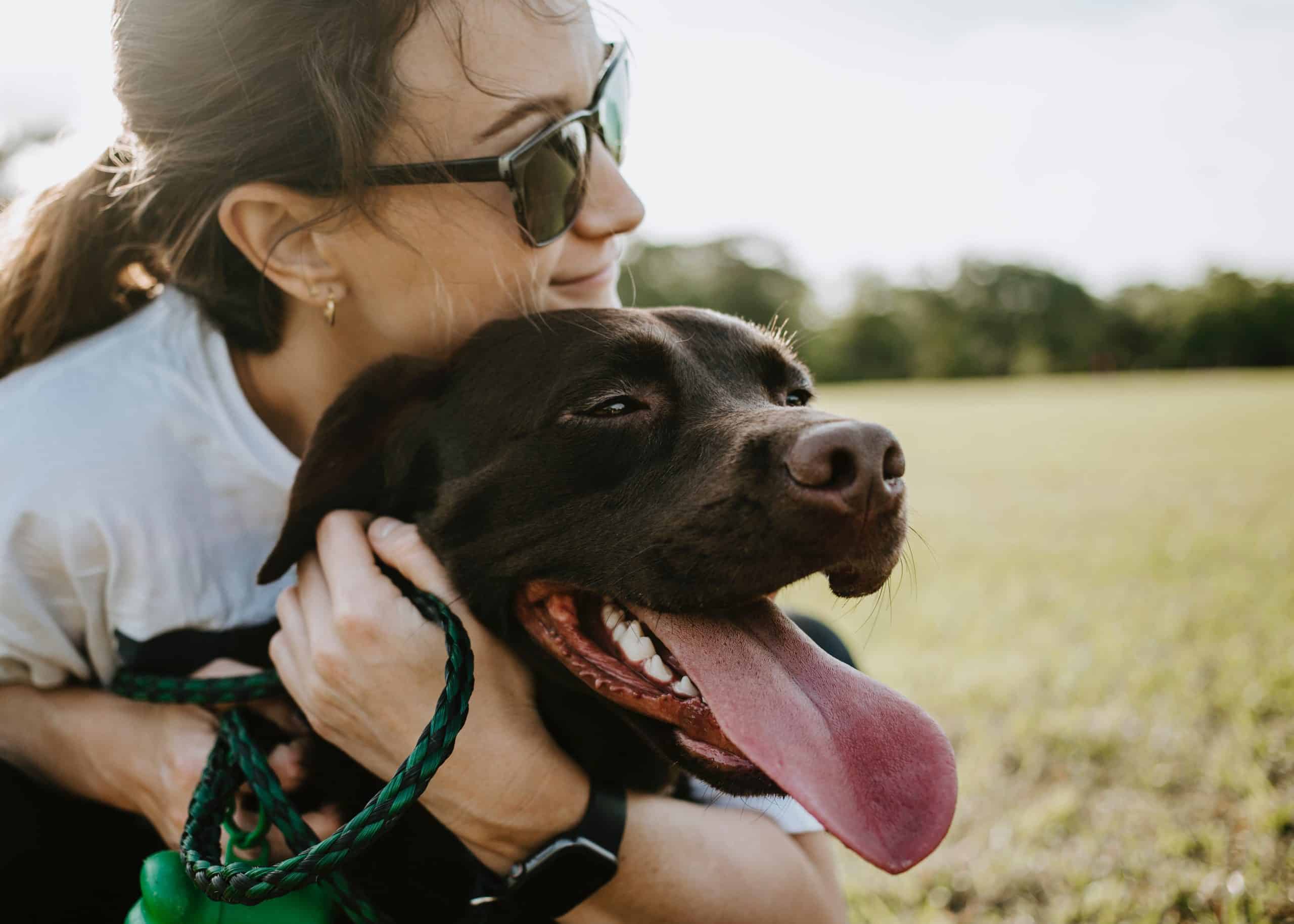 a black dog and a woman