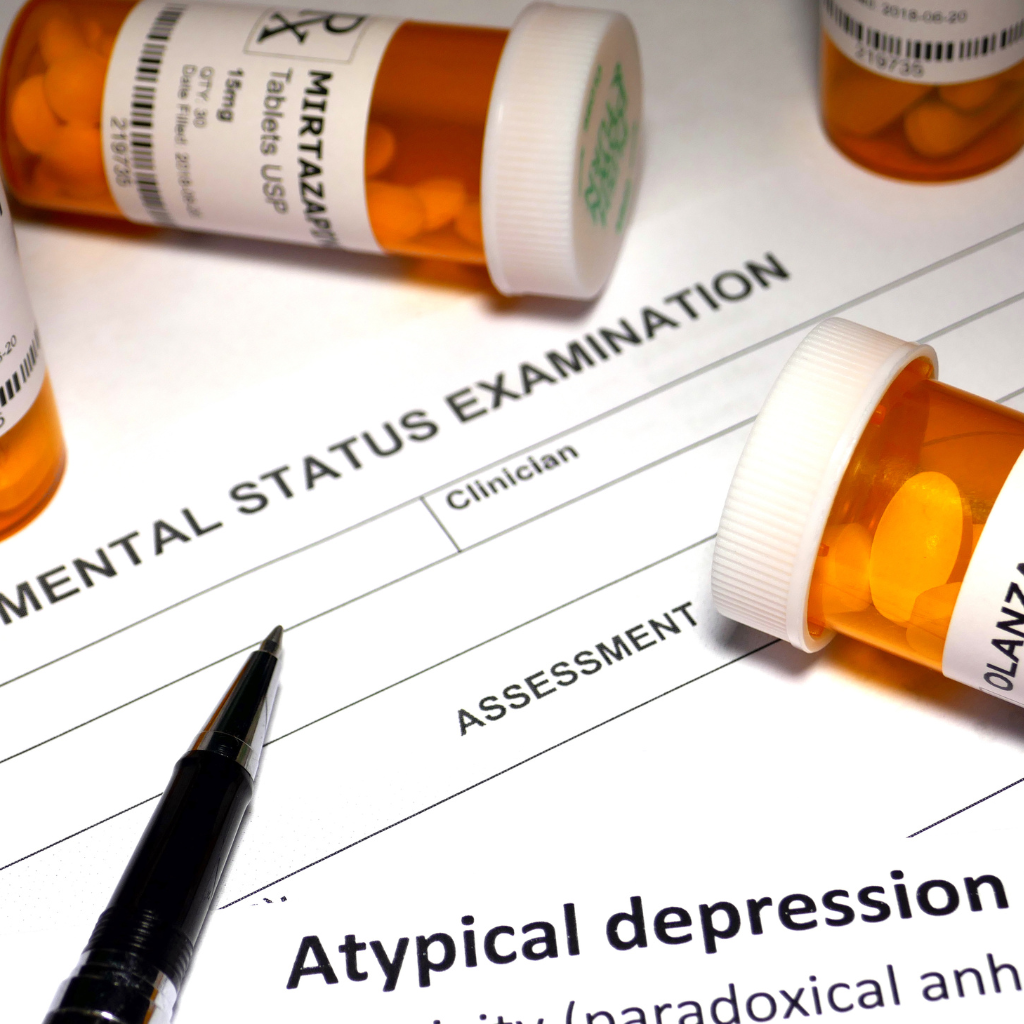 Depression Treatment Simplified: How LAIs and TMS Reduce the Burden of Daily Medications 1 Antidepressant pills beside a mental health assessment form
