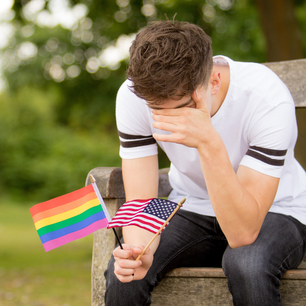 Understanding LGBTQ+ Mental Health Disparities 1 Distressed LGBTQ+ youth holding pride and American flags, reflecting mental health struggles.