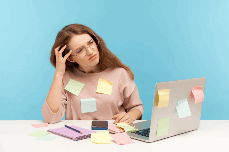 Distracted woman at desk, representing inattentive symptoms linked to ADHD and ADD.