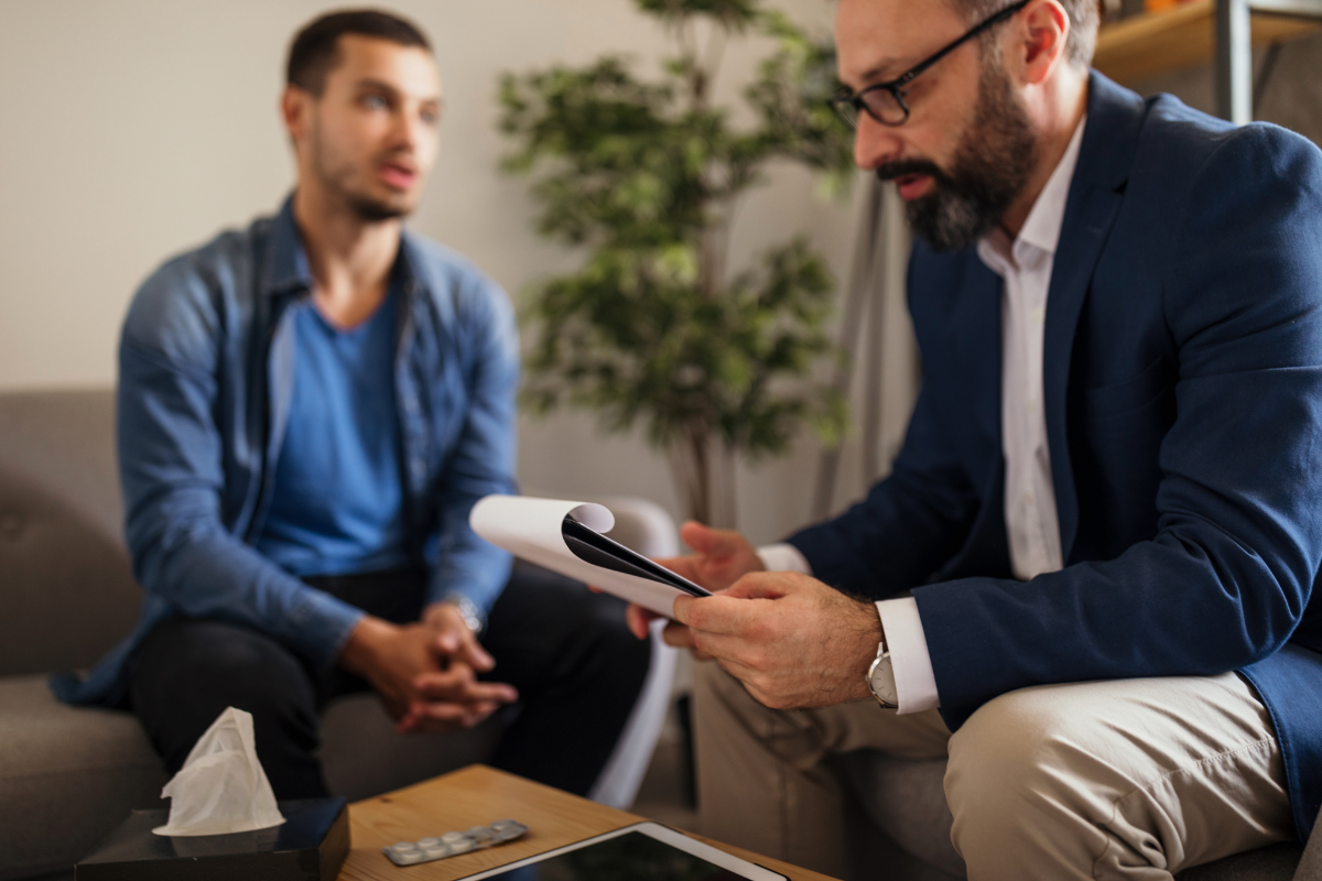 Therapist and patient in session discussing intrusive thoughts and CBT treatment.