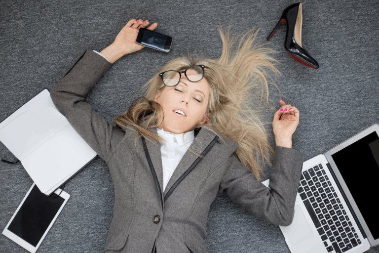Woman experiencing ADHD burnout, surrounded by work items