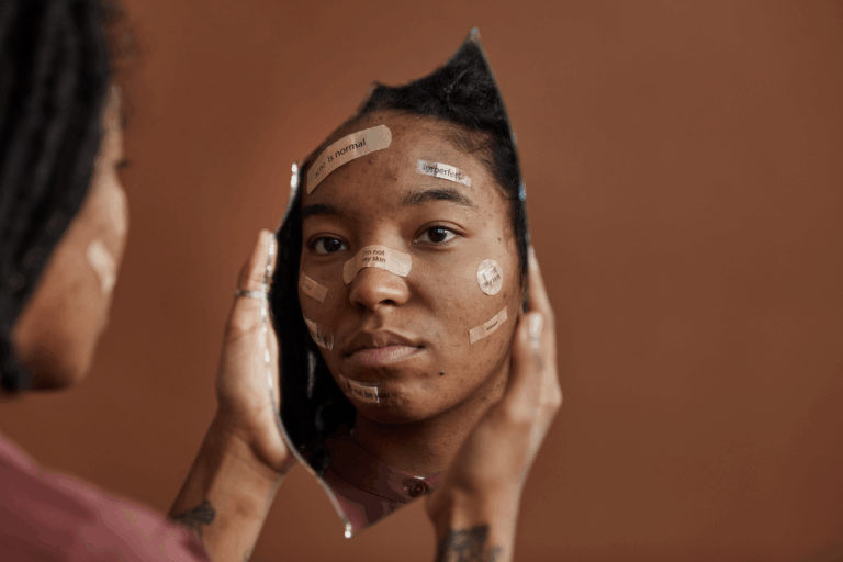 Person holding a mirror, showing how self-esteem shapes mental health.