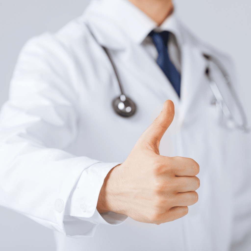 Doctor giving thumbs up, symbolizing FDA support and clinical promise of TMS for anxiety.