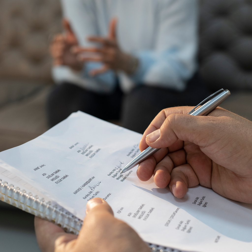 How Motivational Interviewing Helps with Anxiety and Depression 1 Therapist taking notes during a motivational interviewing session focused on personal goals and behavior change