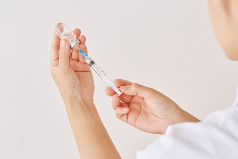 Doctor preparing a long-acting injectable medication for mental health treatment.