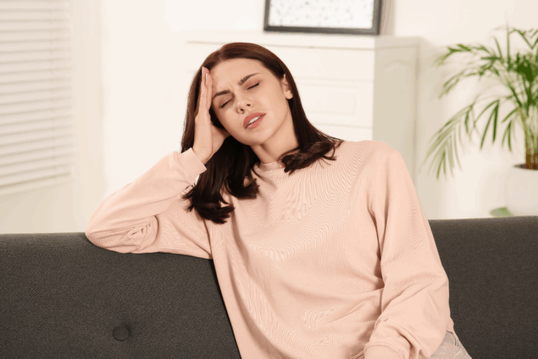 Woman feeling stressed or unwell due to hormonal changes affecting her mood.