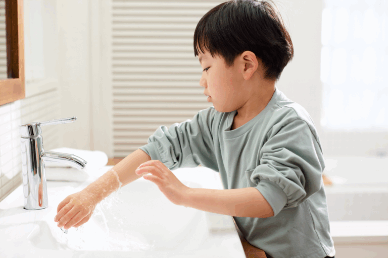 Young child repeatedly washing hands—an early sign of OCD in children affecting daily routines.