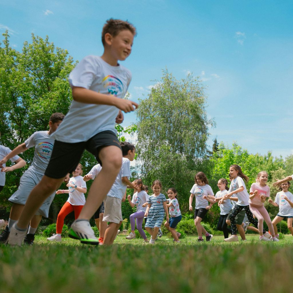 Kids running and playing outside, showing how exercise helps with ADHD management.