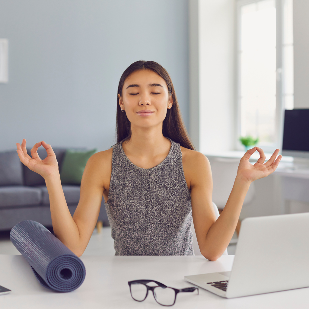 ADHD and Procrastination: Why Starting Feels So Hard 2 Woman practicing mindfulness at her desk, using meditation to manage stress and build healthy routines.