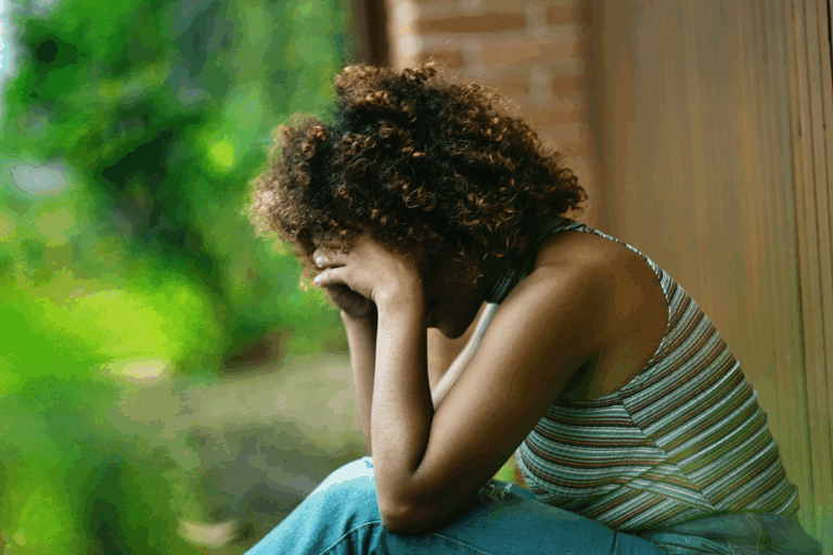 Woman grieving alone after a personal loss.