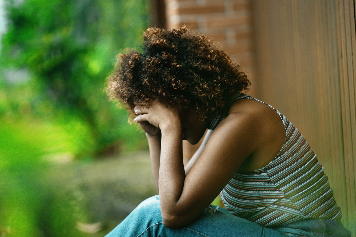 Woman grieving alone after a personal loss.