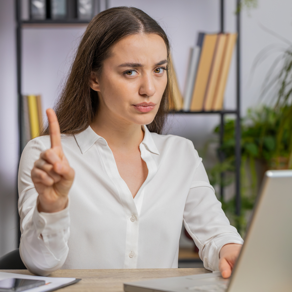 Woman raising her finger in a gesture of saying no and setting a boundary.