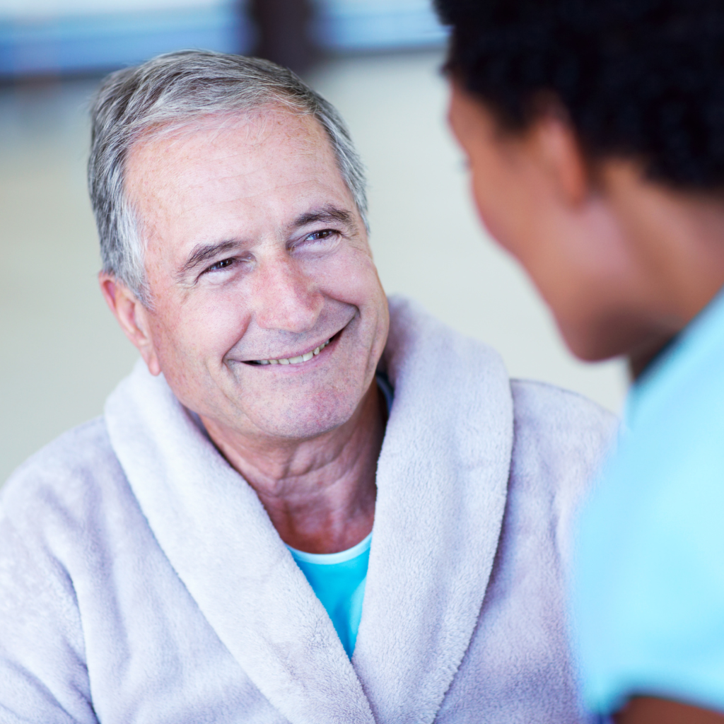 What Is Dialectical Behavior Therapy (DBT) and How It Helps in Managing Mental Health 2 Smiling old man talking with a caregiver, representing how DBT can support recovery from geriatric depression.
