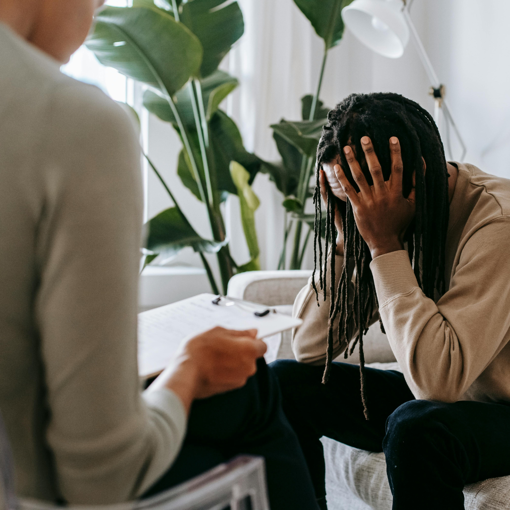 Person in therapy session showing emotional distress.