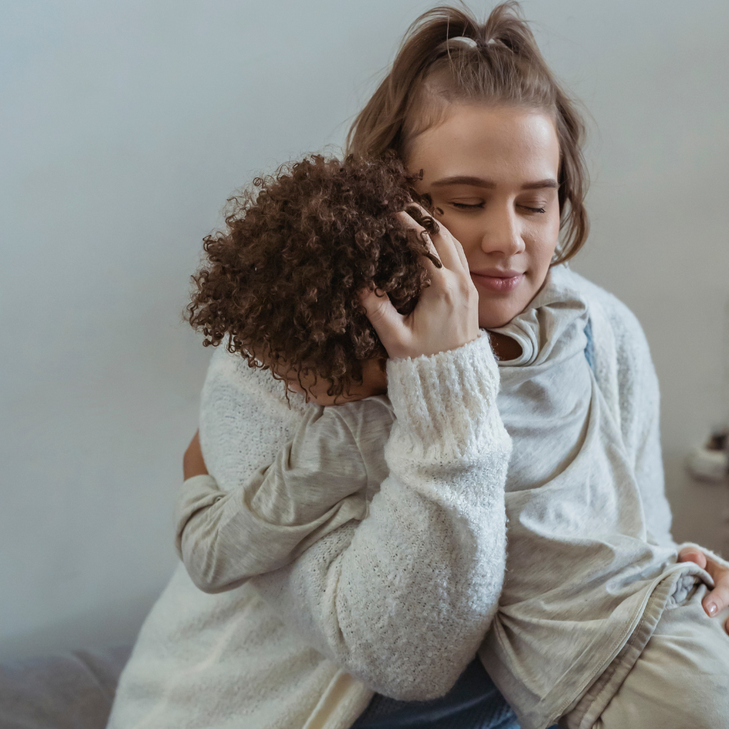 Recognizing and Supporting Bipolar Disorder in Children 2 Mother hugging child, showing support for bipolar disorder in children.