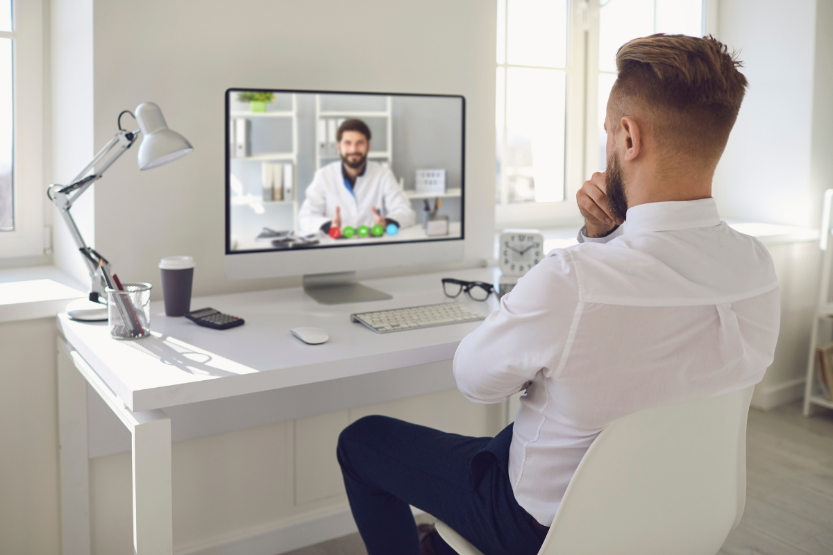 Man attending a telepsychiatry session with a mental health professional via video call.