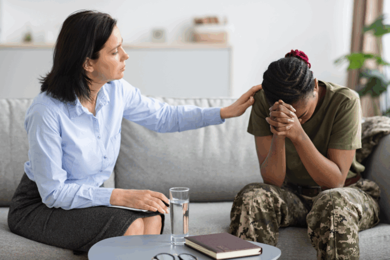 Therapist comforting a distressed female veteran with PTSD.