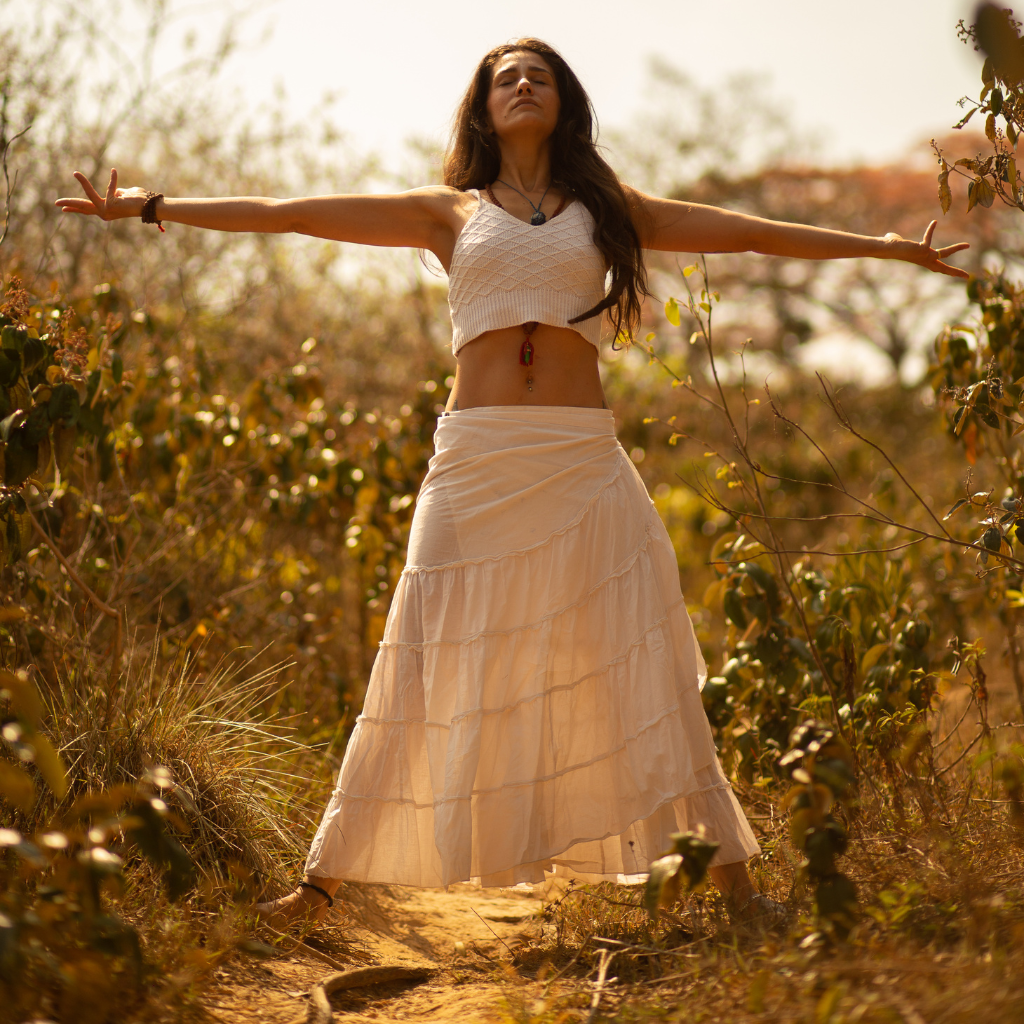 Mindfulness Exercises for Everyday Mental Wellness 1 Woman practicing mindfulness outdoors with open arms in nature.