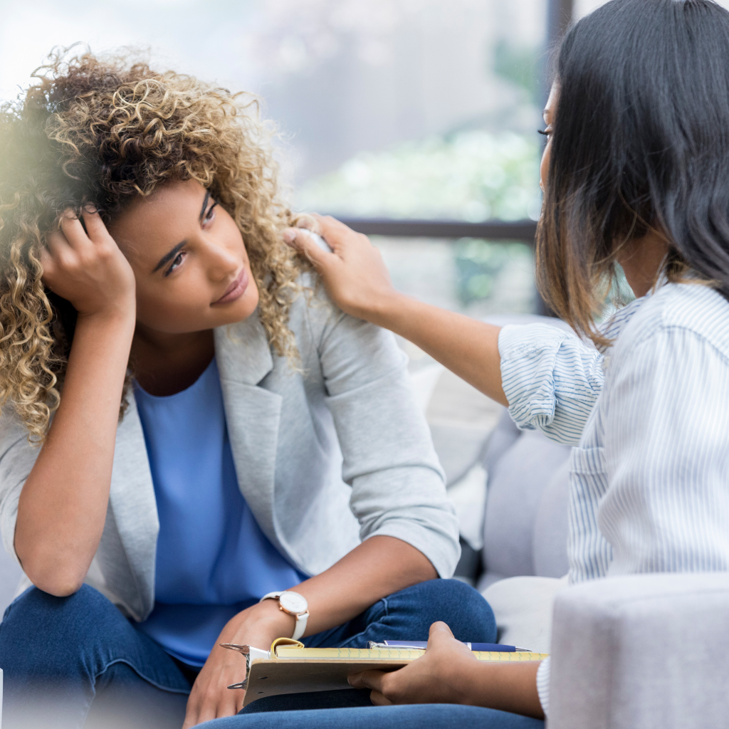 How Generational Trauma Shapes PTSD and Paths to Healing 2 Therapist supporting a woman during a CBT session.