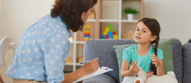 Young girl talking with a therapist during CBT for children session