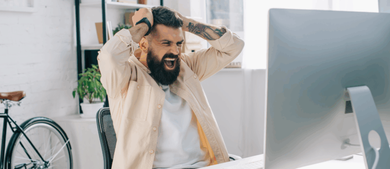 Man showing frustration and distraction at work, reflecting ADHD in men.