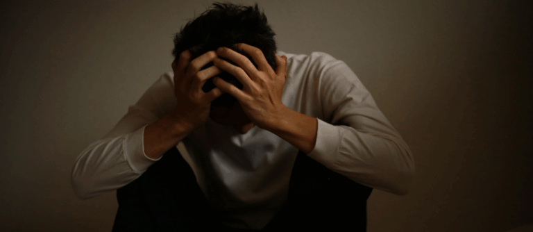 Man experiencing stress and focus challenges related to ADHD.