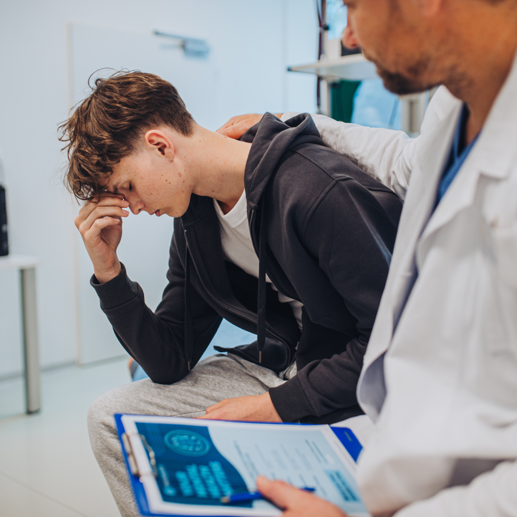 Teen with adolescent anxiety speaking with a doctor for support