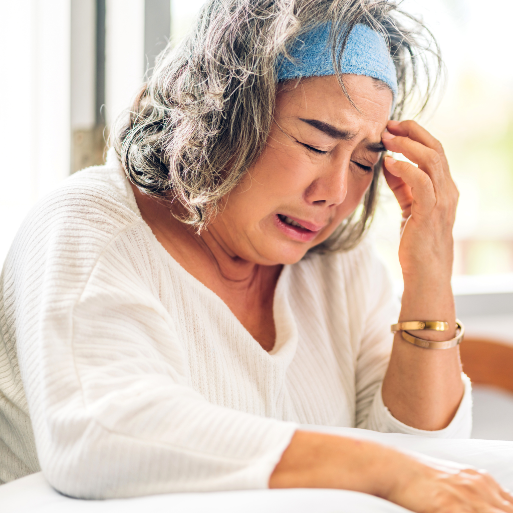 Elderly woman feeling distressed and overwhelmed, illustrating depression in older adults.