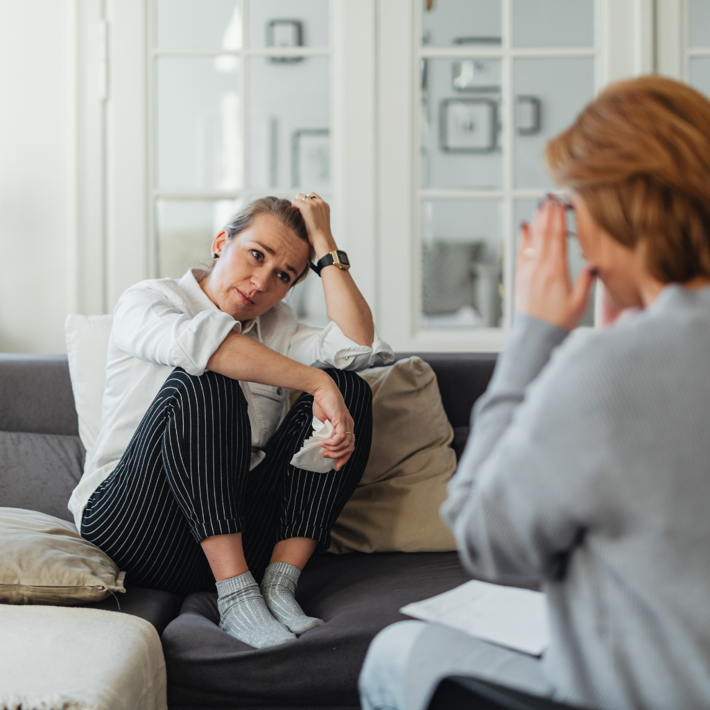 Woman in a therapy session looking concerned, reflecting the need for support in managing atypical depression.