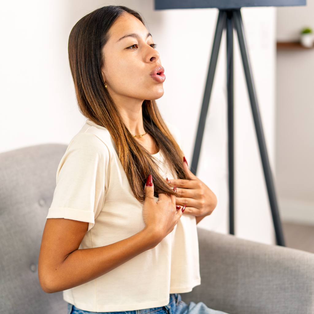Woman practicing slow, controlled breathing to help manage trauma-related stress and grounding.