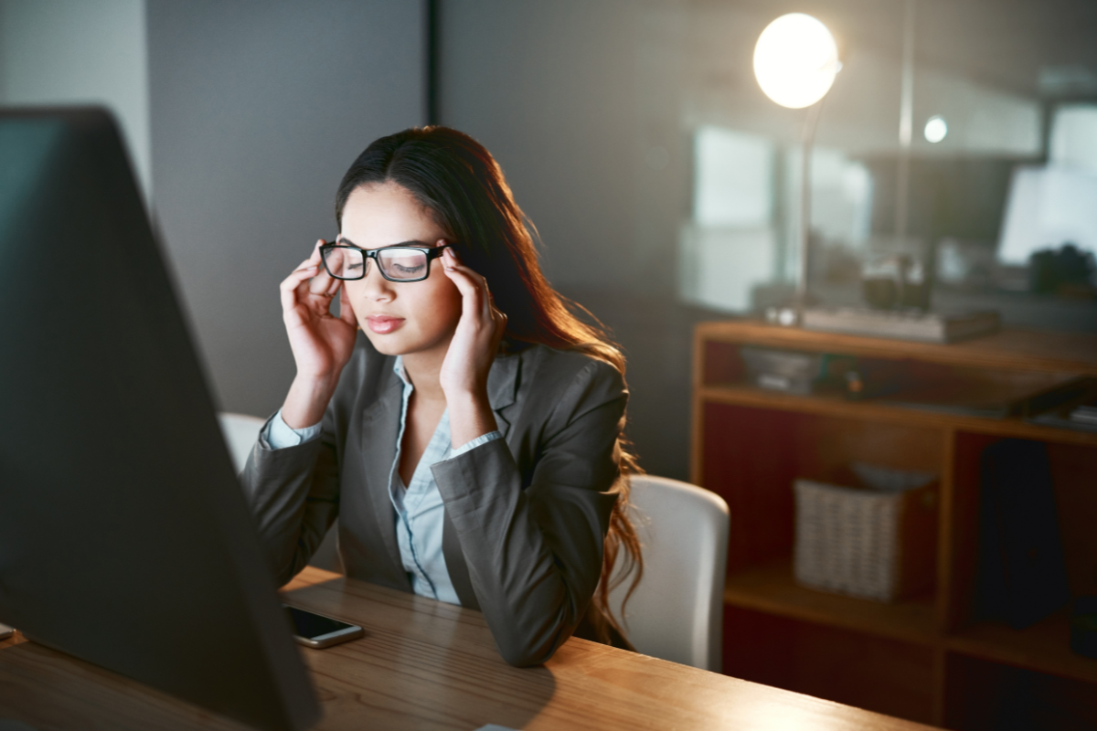 Woman maintaining focus at work while coping with hidden emotional fatigue.