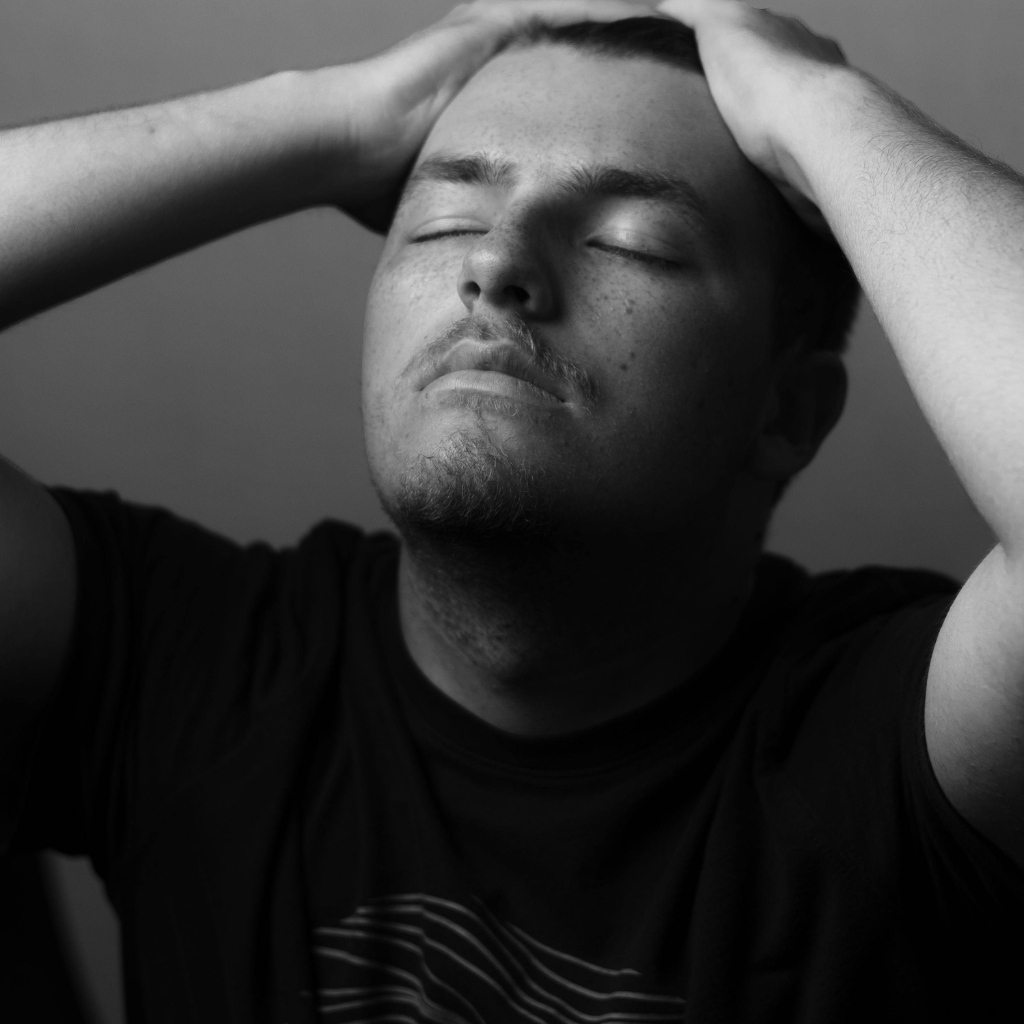 Pure O OCD or Purely Obsessional OCD: What is it, Symptoms and Treatment 1 Person holding their head, overwhelmed by intrusive thoughts.