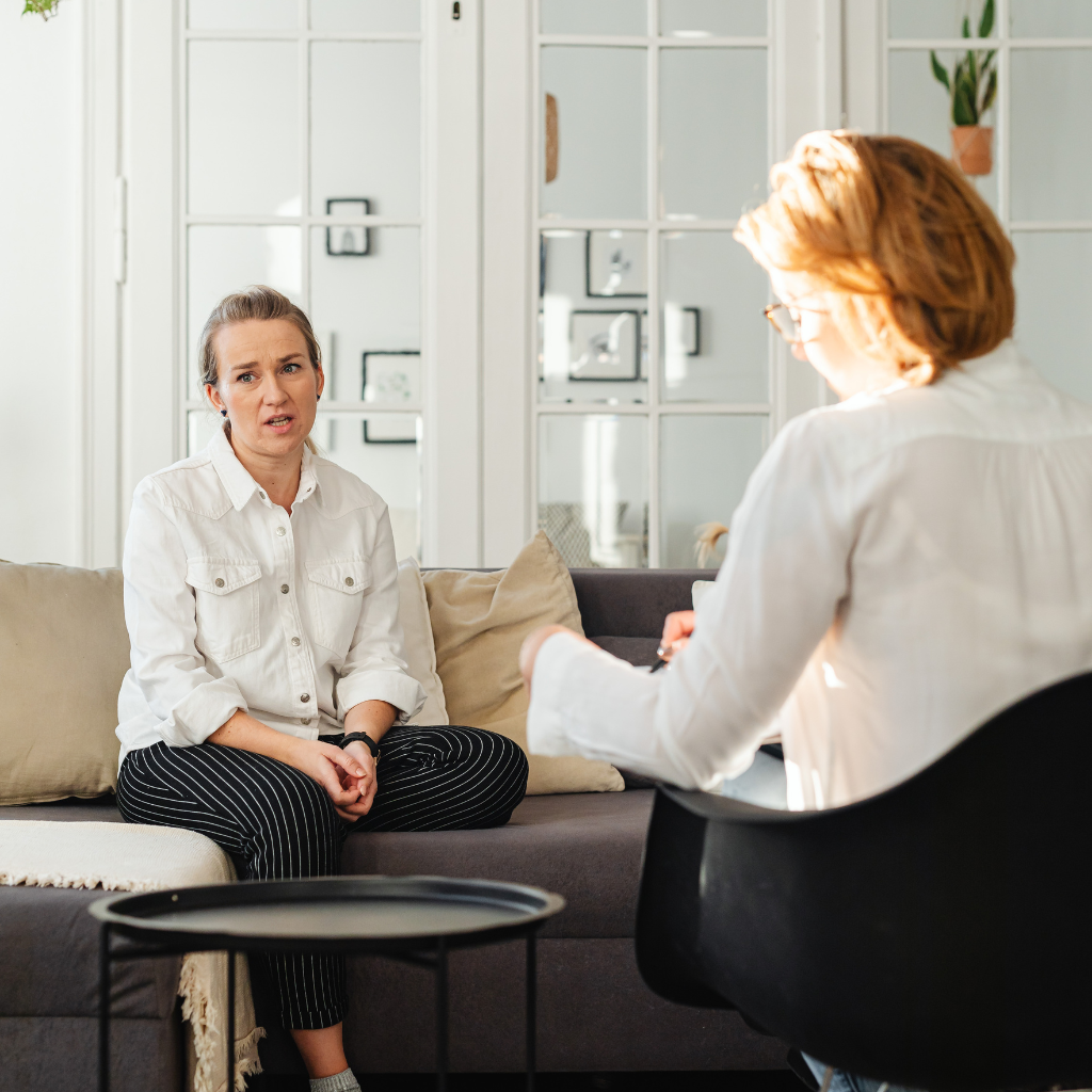 woman speaking with a therapist during a counseling session for depression and emotional support.