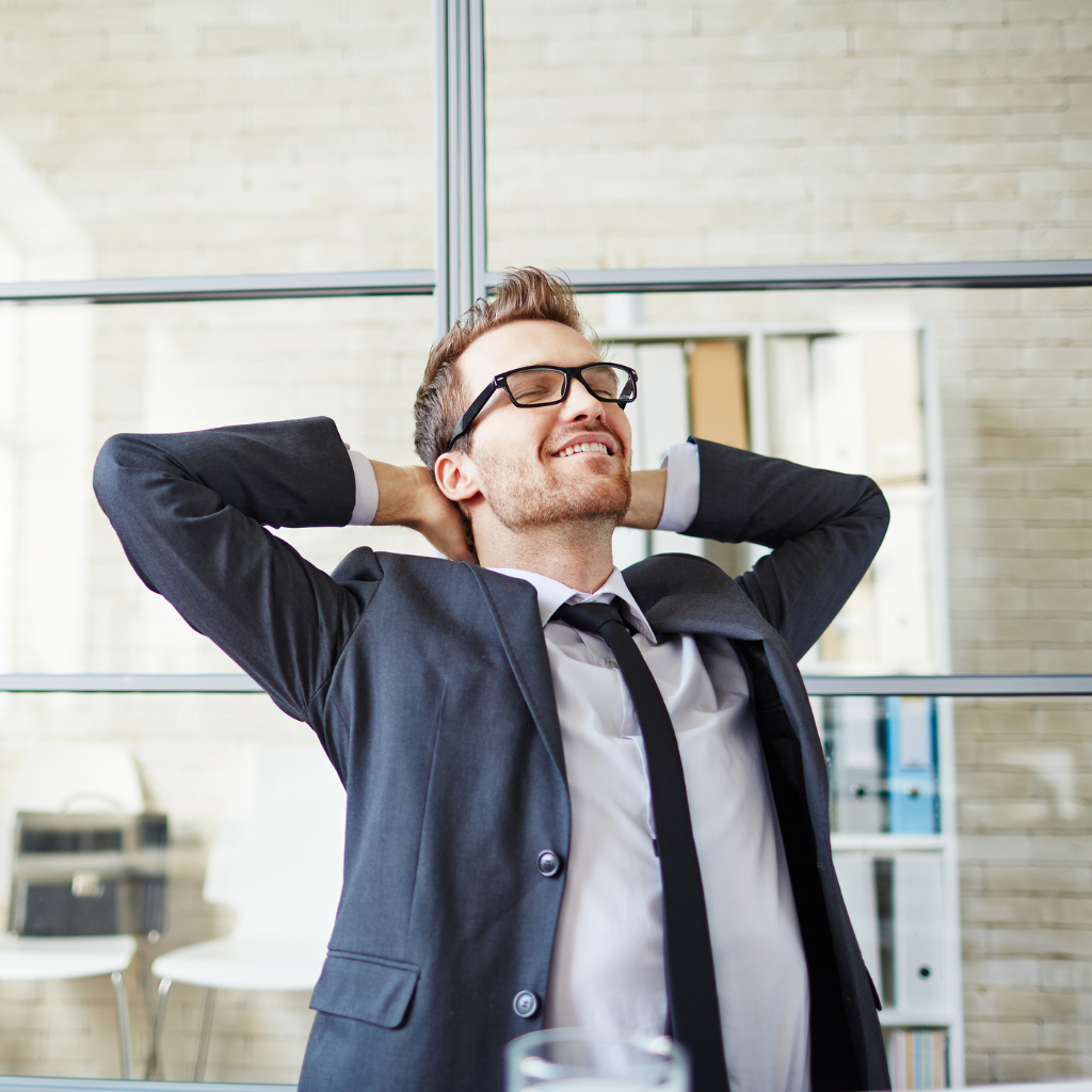 Employee taking a break and stretching to manage work stress and anxiety.