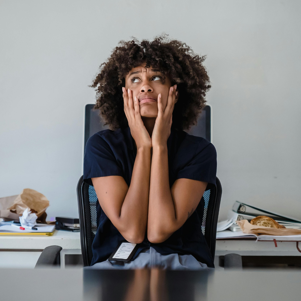 Woman maintaining composure at work while struggling with internal low mood and self-doubt.