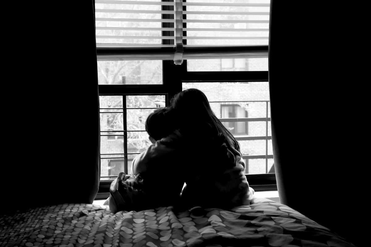 Siblings holding each other in a quiet moment of support