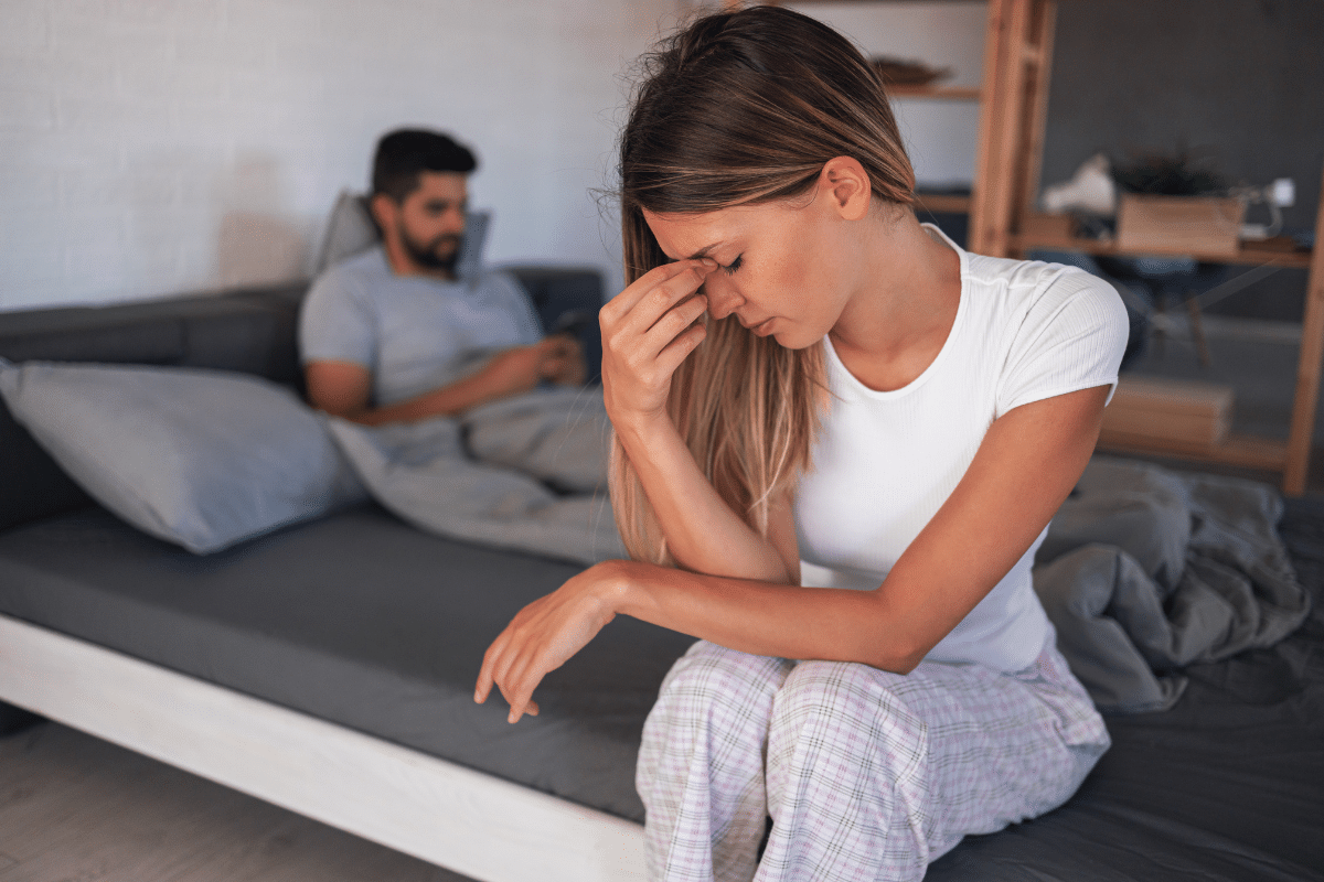 Woman showing emotional distress in a strained relationship dynamic
