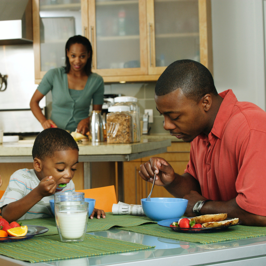 Parents and child eating a balanced meal together at home, illustrating healthy eating routines that support eating disorder prevention