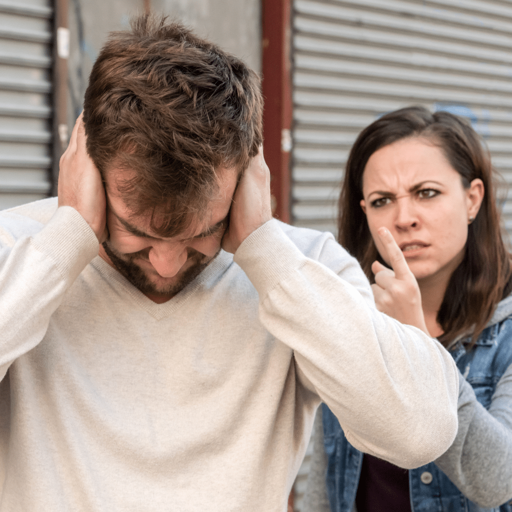 Person overwhelmed during emotional conflict, showing what is trauma bonding can look like