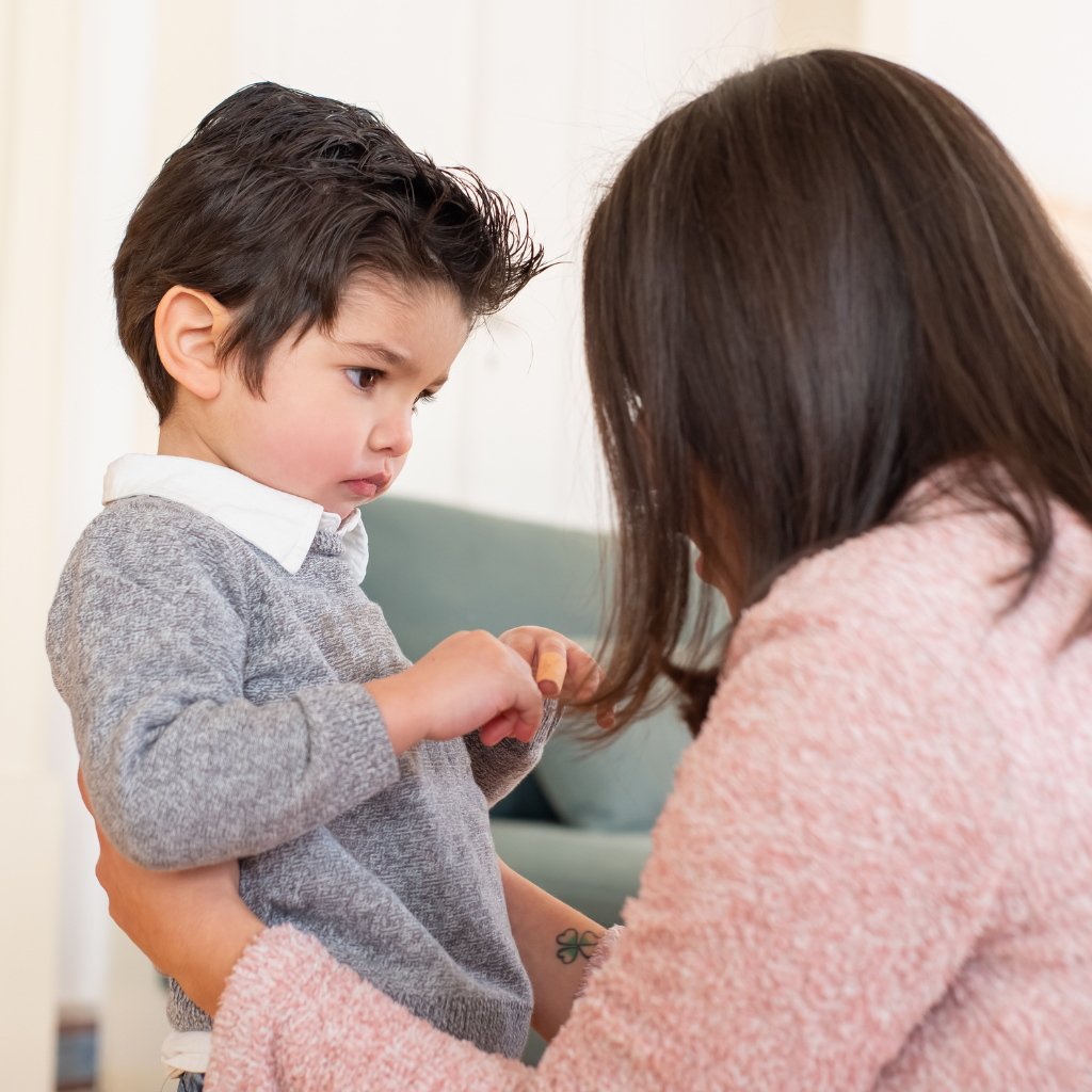 Parent calmly comforting a young child during a moment of anxiety at home