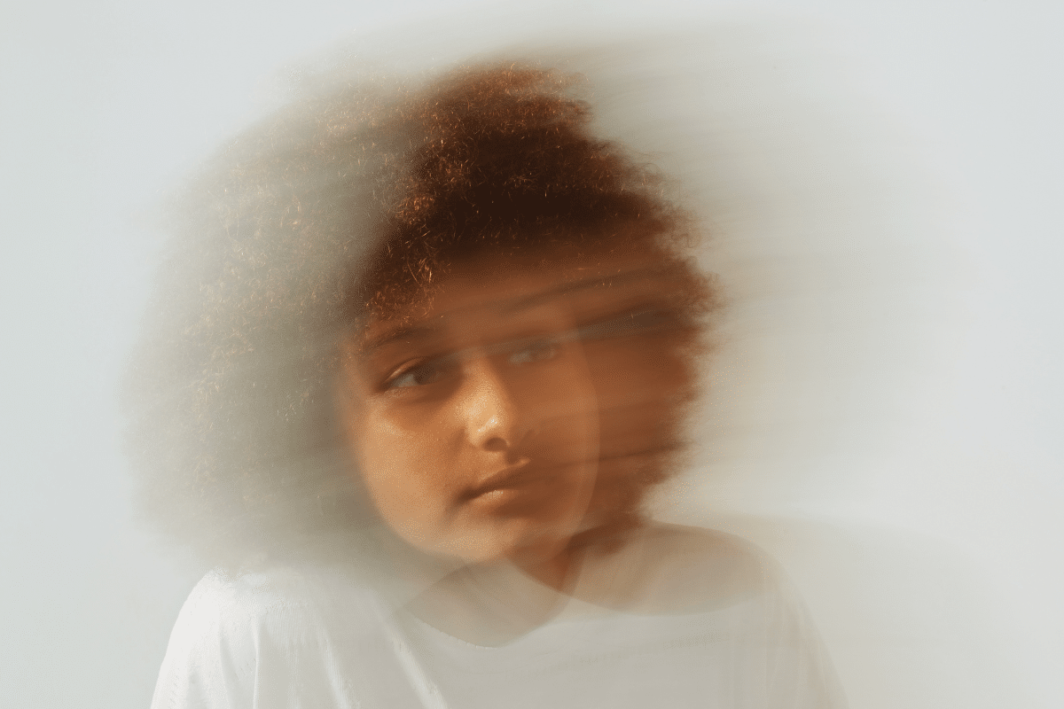 Blurred portrait of a person with subdued expression representing melancholic depression and emotional flatness