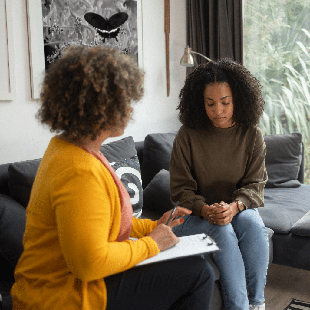 Therapist speaking with a patient during a counseling session for emotional numbness treatment
