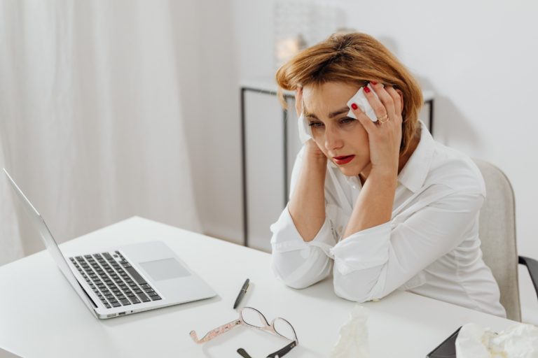 Woman looking worried while researching symptoms online, representing health anxiety or hypochondria.