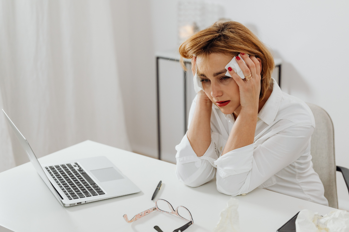 Woman looking worried while researching symptoms online, representing health anxiety or hypochondria.