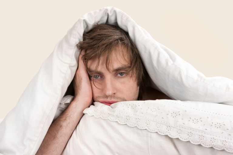 Person lying awake in bed, showing chronic insomnia and sleep difficulty