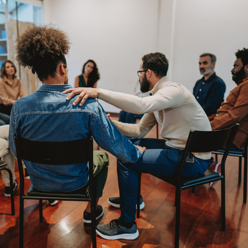 What Is Secondary Traumatic Stress — And Could It Be Happening to You? 2 Support group setting with participants in discussion, illustrating peer support in treating secondary traumatic stress.